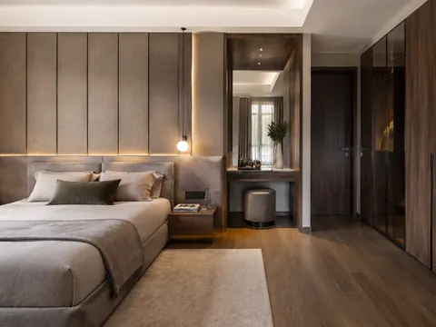 Bedroom with dressing niche: Bed and side dressing zone, Walnut veneer and Greige upholstery