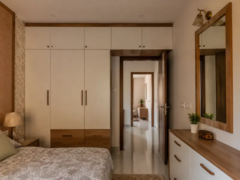 Wardrobe around a doorway: Storage follows the wall around an existing doorway, using the upper area for infrequently needed items.